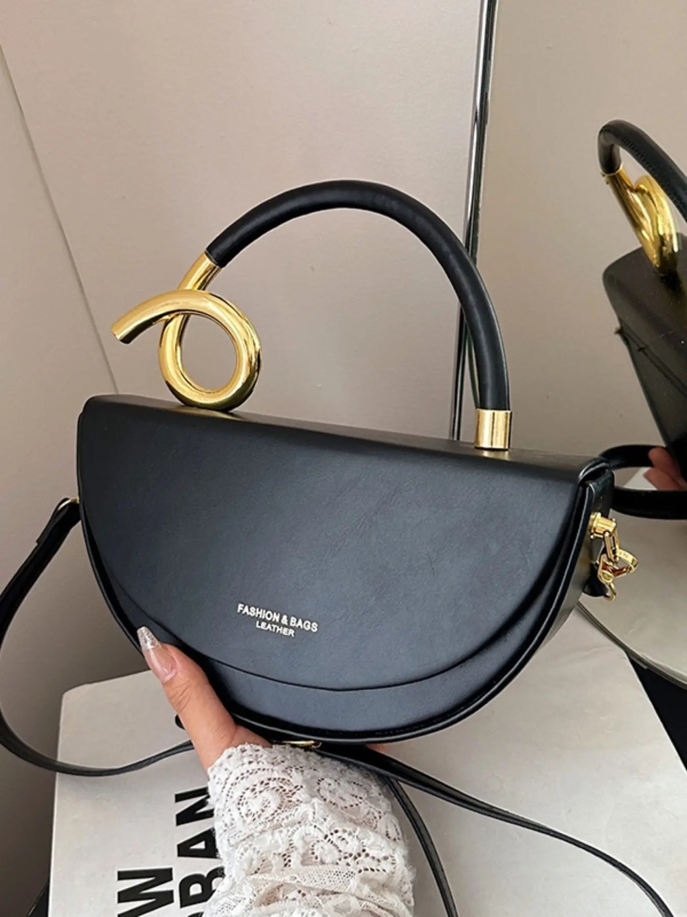 Black Half-Moon Shoulder Bag with Sculptural Gold Handle